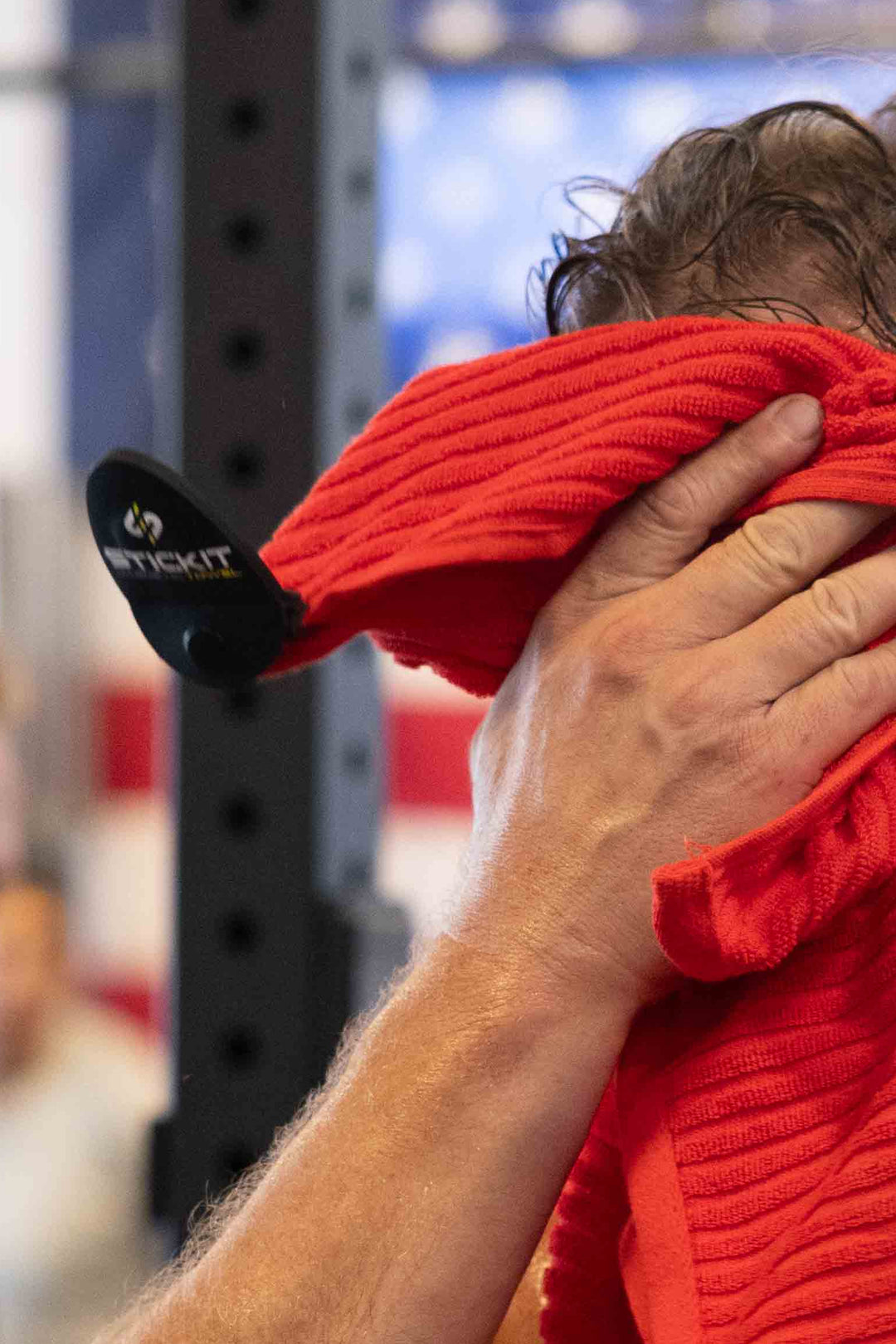 Red workout towel made of soft, absorbent material, ideal for gym use and heavy workouts.