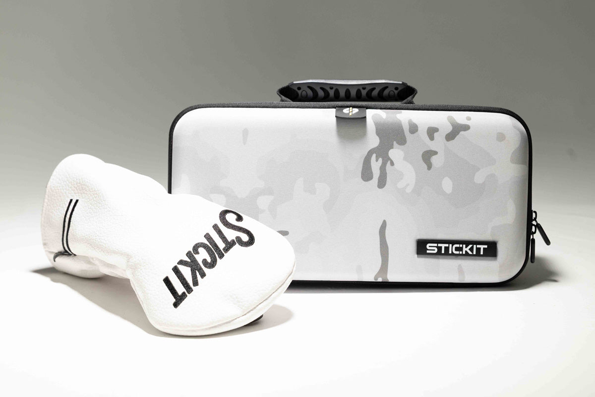 Gray camo Stickit bag with black accents and a white glove, perfect for sports equipment storage and organization.
