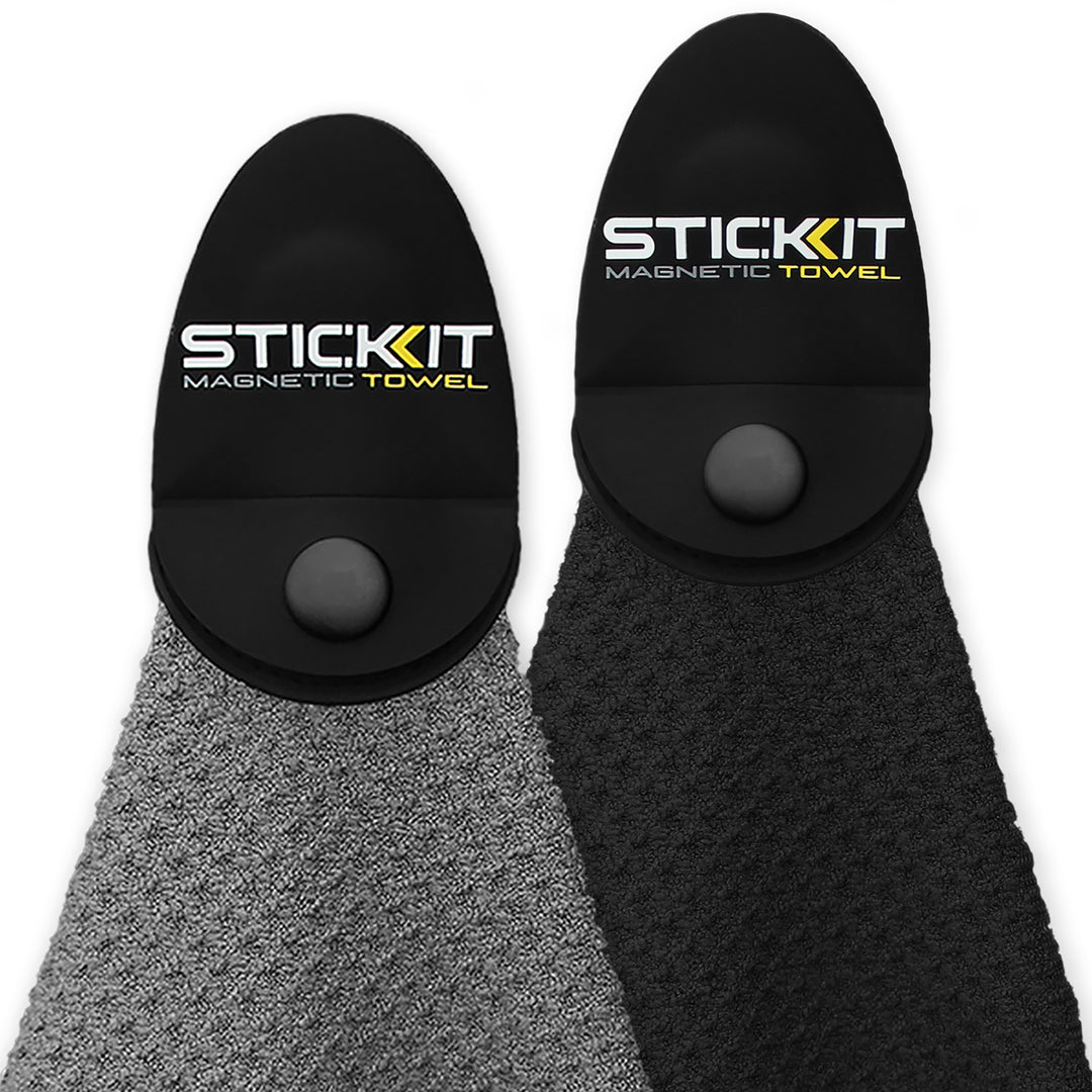 Black and gray STICKIT Magnetic Towels with textured fabric and logo; perfect for gym or outdoor use.
