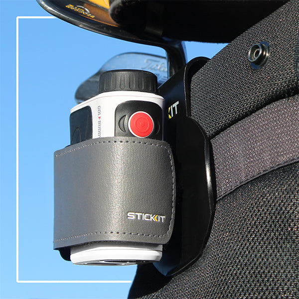 Gray leather golf rangefinder holder with red button, securely attached to a golf bag, ideal for easy access.
