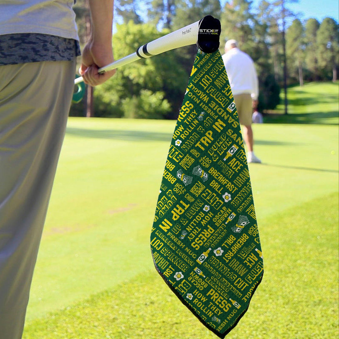 Green and yellow golf towel with text design, made of microfiber, perfect for golfers on the course.