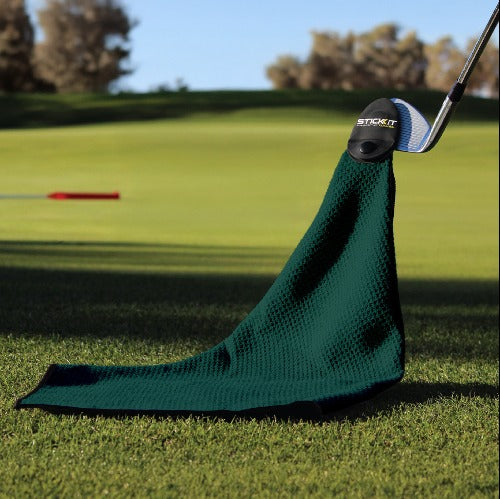 Green microfiber golf towel with textured weave, designed for easy attachment to clubs on the course.