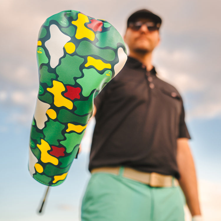 Colorful camo golf cover in green, yellow, and red; durable material with modern style for golf club protection.