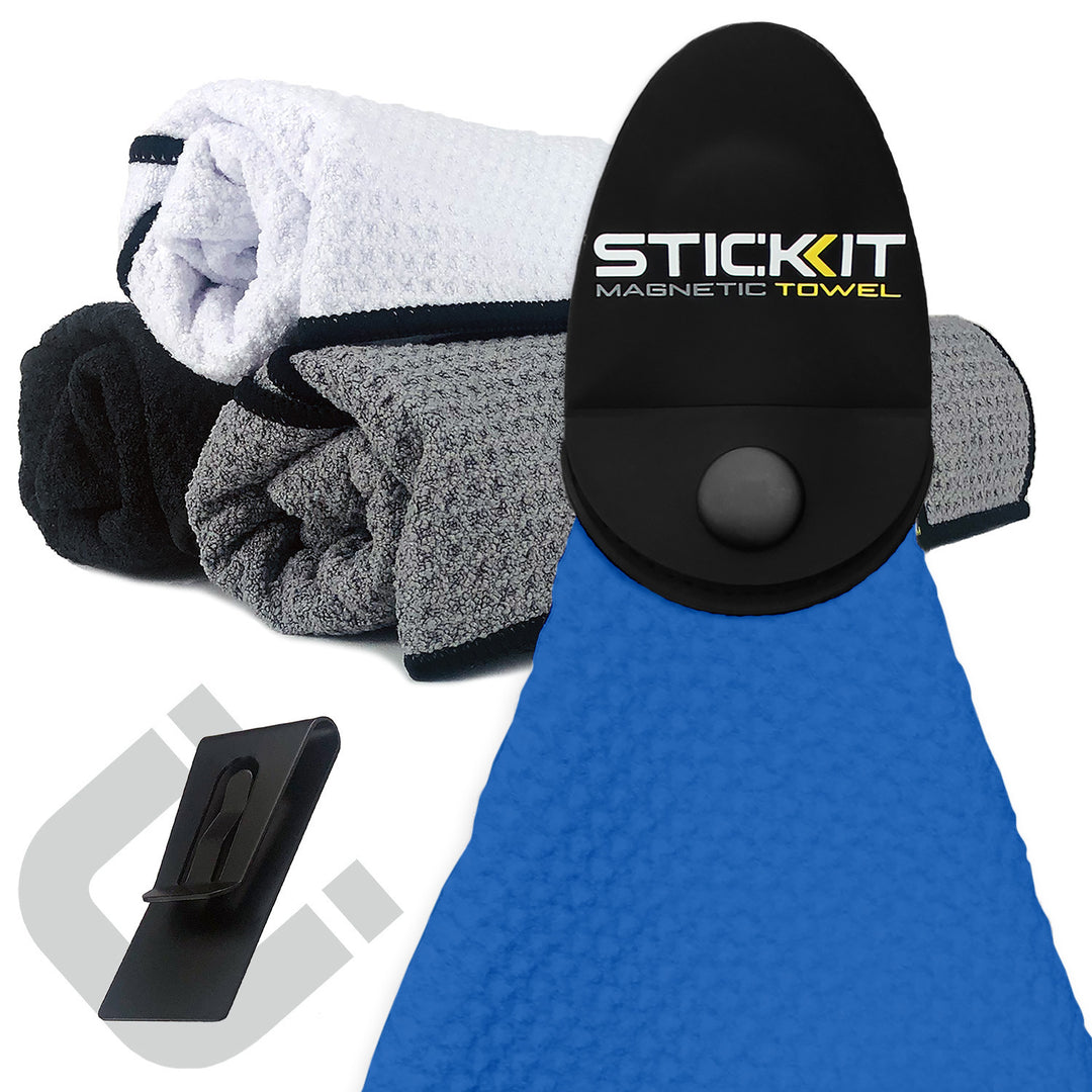 Blue magnetic towel with a textured finish, featuring a black clip and stacked gray and black towels in the background.