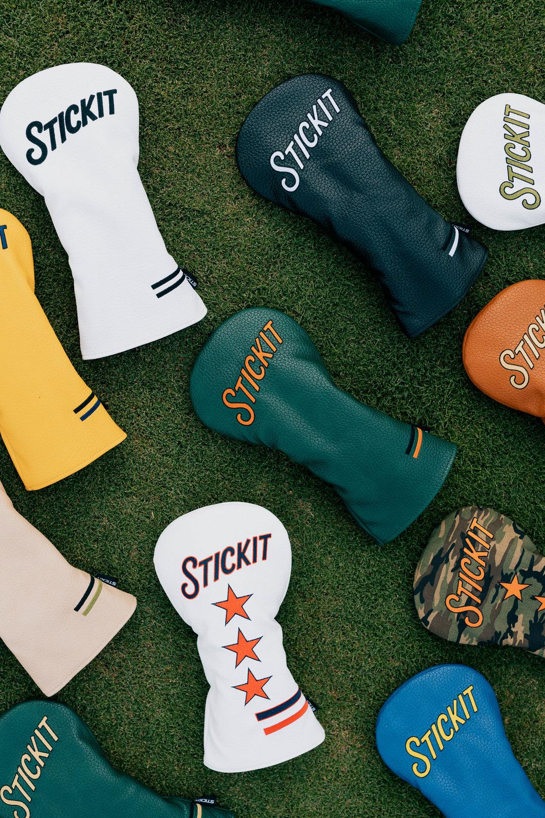 Colorful leather golf headcovers in white, green, yellow, brown, and camouflage with "STICKIT" logo designs.