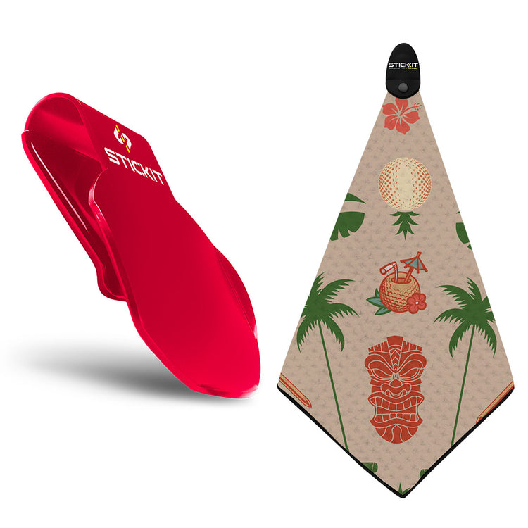 Red silicone golf towel clip with a tan patterned towel featuring tropical designs and a tiki motif.