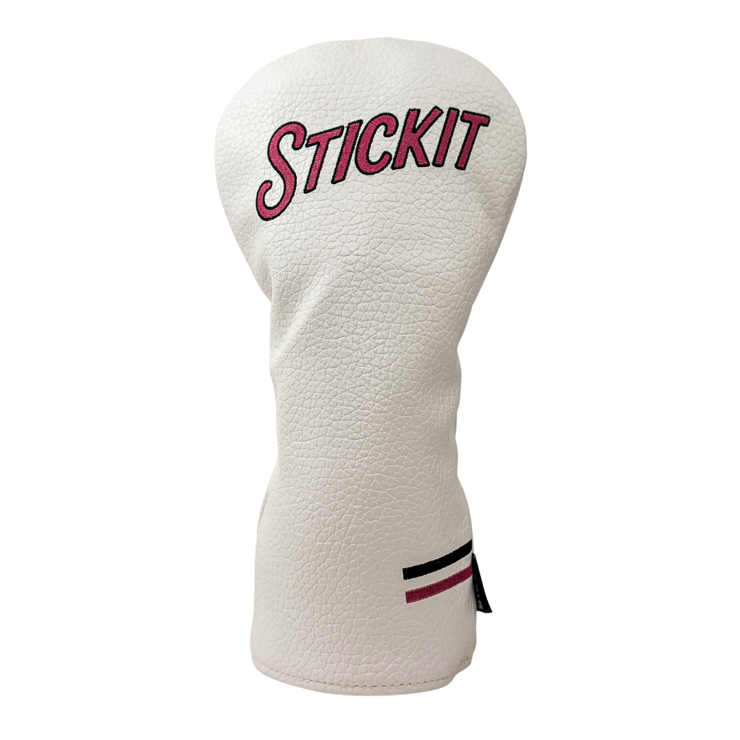 White leather golf head cover with pink "STICKIT" embroidery and black and pink stripe detail.