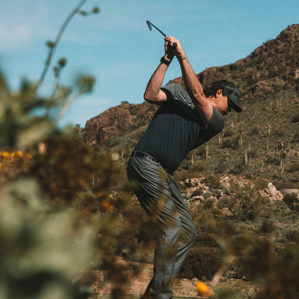 Men's golf attire in navy and gray, made from lightweight moisture-wicking material for optimal performance on the course.