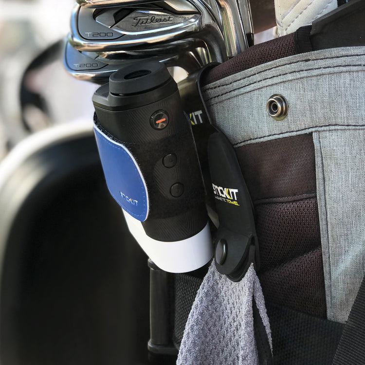Golf bag with STICKIT magnetic rangefinder strap and classic golf towel attached, showing easy access magnetic golf accessories on course