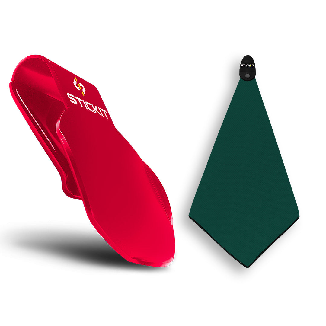 Red silicone golf tee holder and green golf towel, durable, stylish accessories for golf enthusiasts.