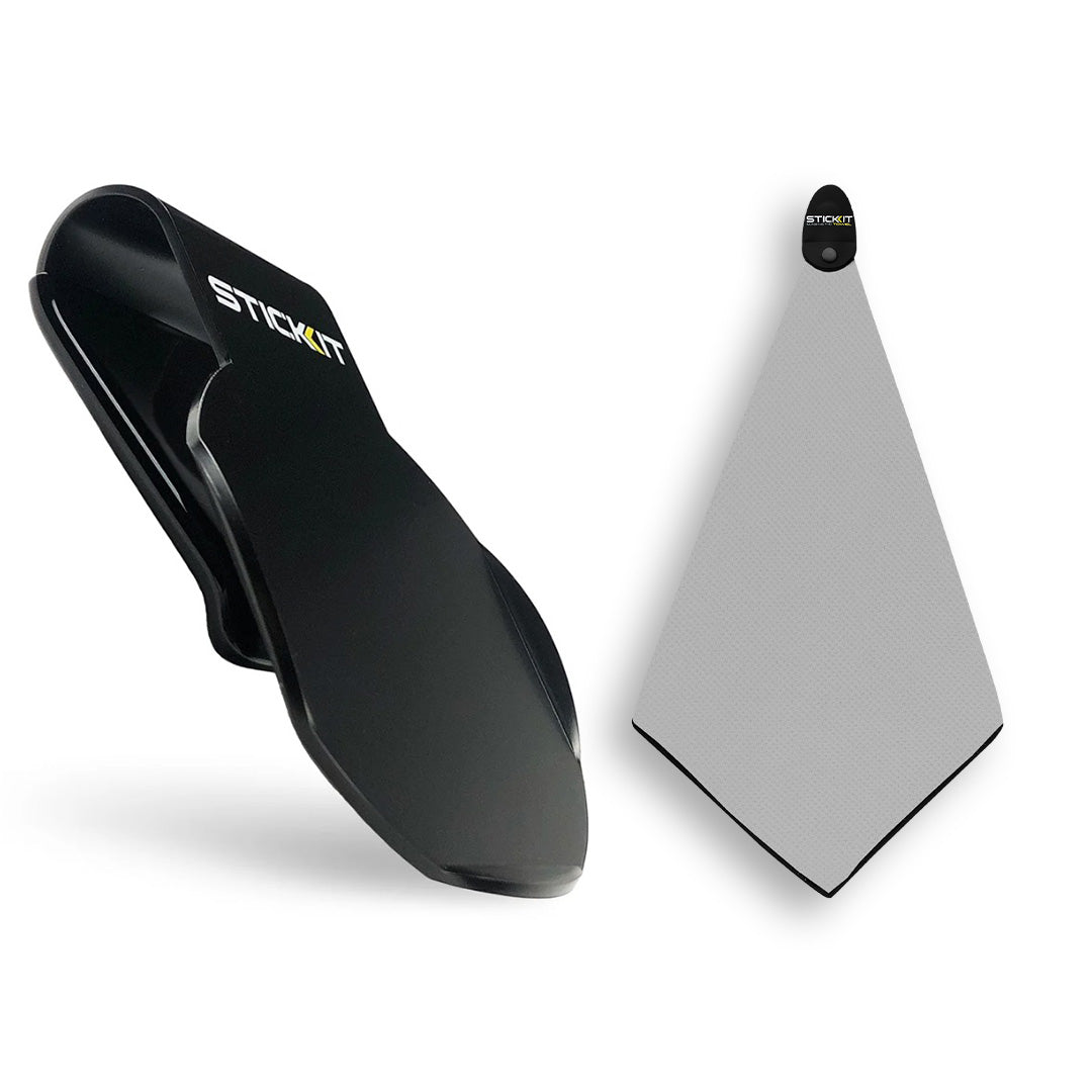 Black Stick-it clip and gray microfiber towel, designed for sports and outdoor activities.