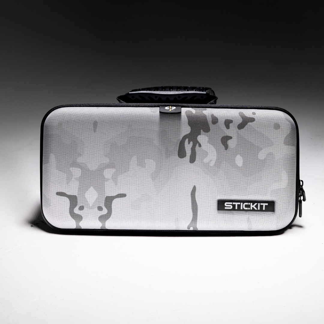 Gray camouflage hard-shell case with a sturdy handle, ideal for carrying equipment or accessories.