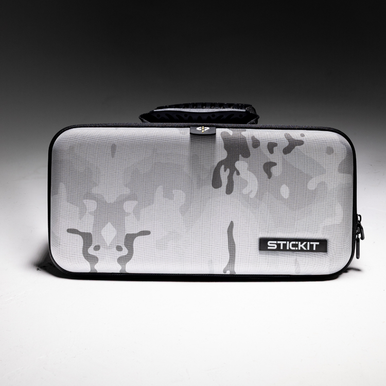 Gray camouflage hard-shell case with a sturdy handle, ideal for carrying equipment or accessories.