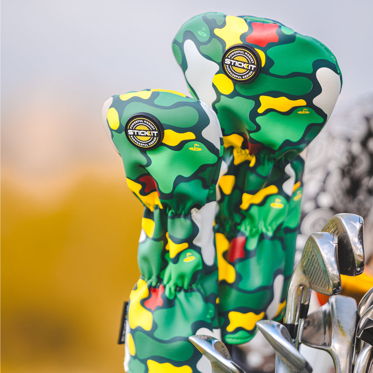 Green camouflage golf headcovers with yellow and red accents, made from durable synthetic material, stylish and functional.