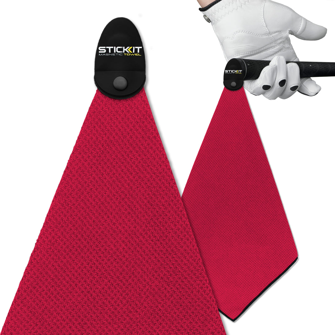Magenta microfiber golf towel with magnetic clip, ideal for easy access during games. Durable and stylish accessory.