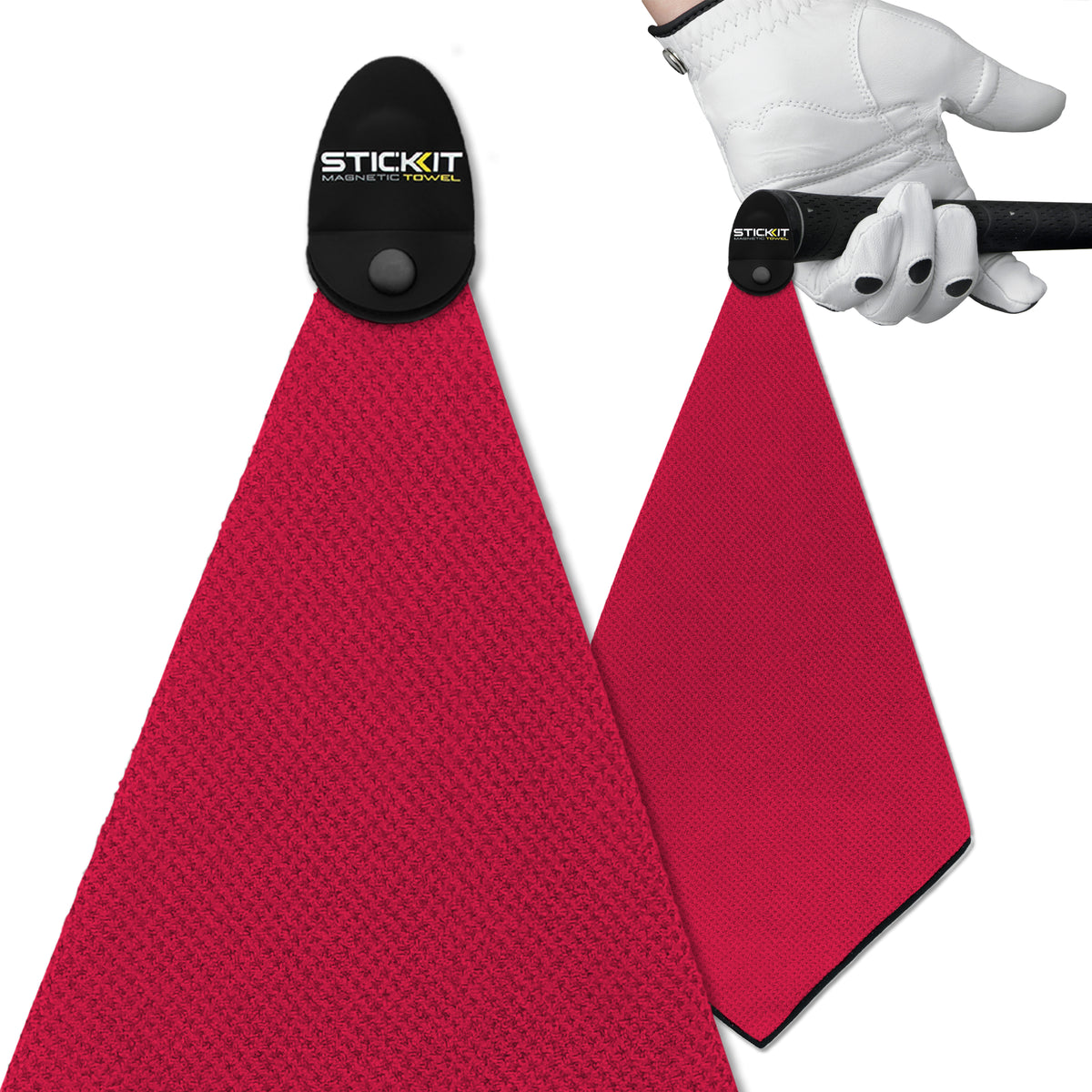 Magenta microfiber golf towel with magnetic clip, ideal for easy access during games. Durable and stylish accessory.
