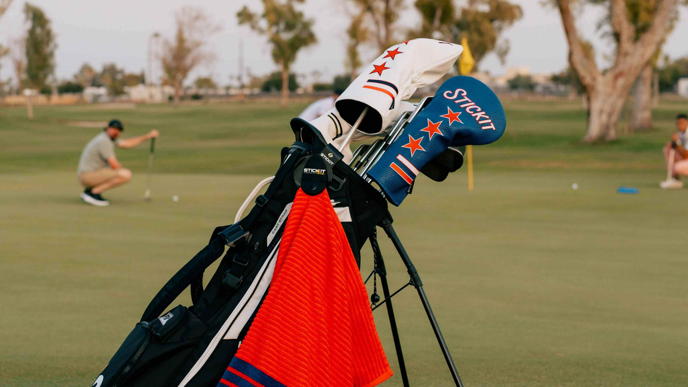 STICKIT Magnetic golf gear featuring the red magnetic XL towel, Heritage Magnetic Headcovers, and black Landing Pad.