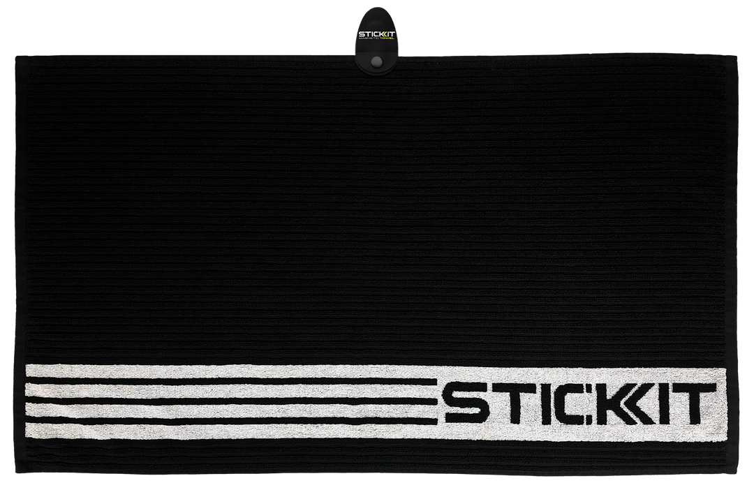 Black textured towel with white STICKIT branding, made from absorbent fabric, ideal for gym or sports use.