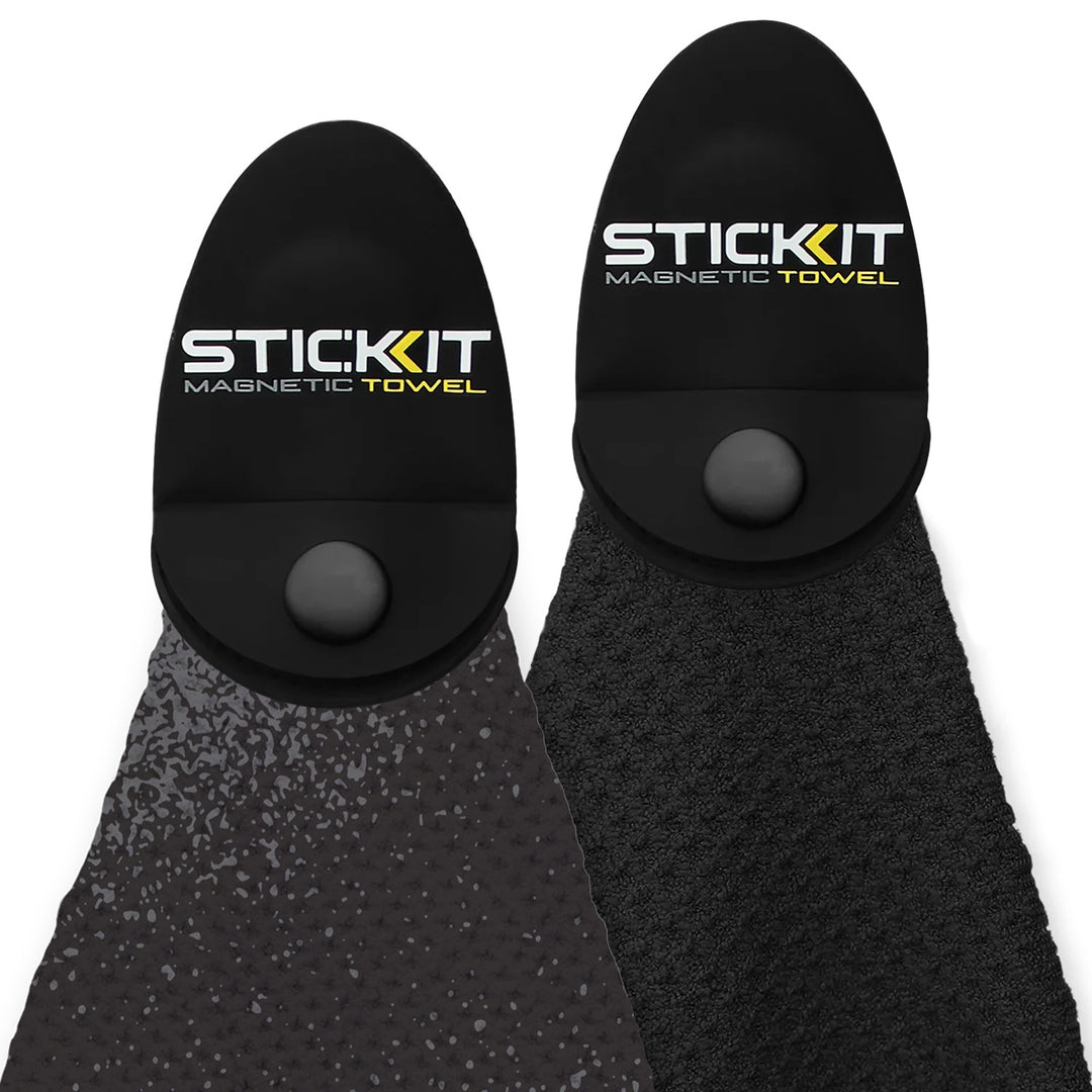 Two Stic Kit magnetic towels in black and dark grey, featuring textured material and unique snap-on design.