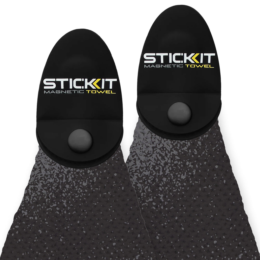 Black magnetic towel with textured surface, featuring STIC:KIT logo for active lifestyle use.