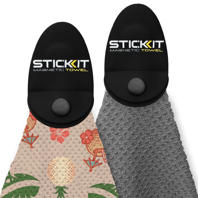 Black magnetic towel with tropical print on one side and grey on the other, perfect for beach or gym use.