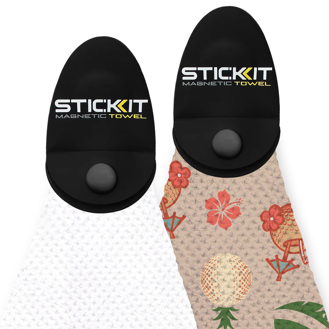 Black magnetic towel holder with white textured towel and patterned tropical design towel featuring floral motifs.