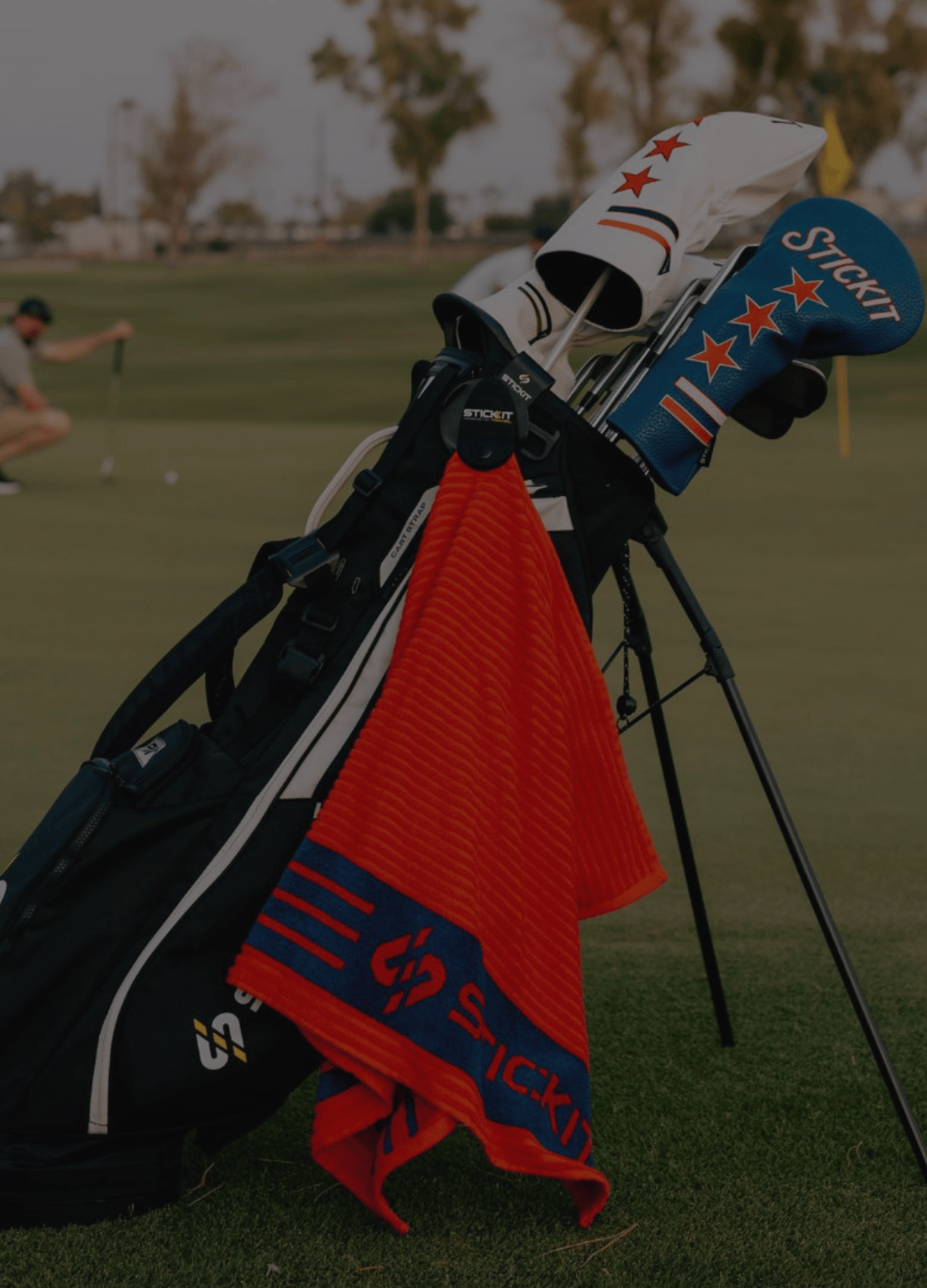 Black golf bag with red and blue stars towel, featuring vibrant colors and modern design for stylish golfing.